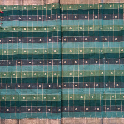 Multicoloured (Turquoise blue & green)soft silk cotton saree with zari woven checks & buttas all over, zari woven double side borders, tissue pallu,multicoloured running blouse with borders & buttas. NS24