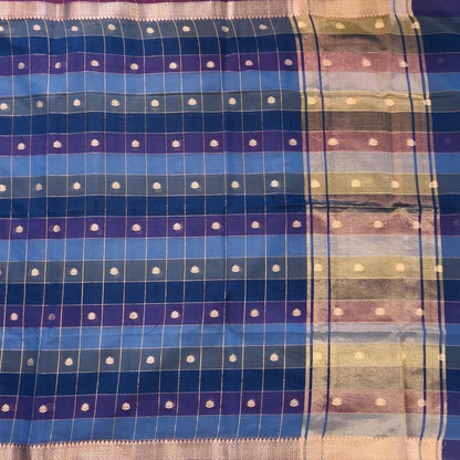 Multicoloured (Light& dark blue)soft silk cotton saree with zari woven checks & buttas all over, zari woven double side borders, tissue pallu,multicoloured running blouse with borders & buttas. NS32