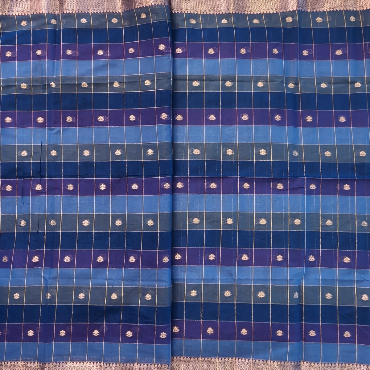 Multicoloured (Light& dark blue)soft silk cotton saree with zari woven checks & buttas all over, zari woven double side borders, tissue pallu,multicoloured running blouse with borders & buttas. NS32