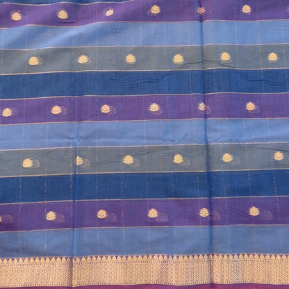 Multicoloured (Light& dark blue)soft silk cotton saree with zari woven checks & buttas all over, zari woven double side borders, tissue pallu,multicoloured running blouse with borders & buttas. NS32