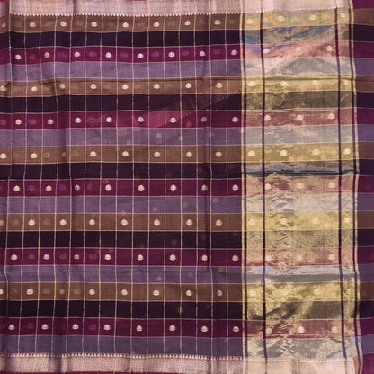 Multicoloured (Purple & maroon)soft silk cotton saree with zari woven checks & buttas all over, zari woven double side borders, tissue pallu,multicoloured running blouse with borders & buttas. NS28
