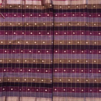 Multicoloured (Purple & maroon)soft silk cotton saree with zari woven checks & buttas all over, zari woven double side borders, tissue pallu,multicoloured running blouse with borders & buttas. NS28