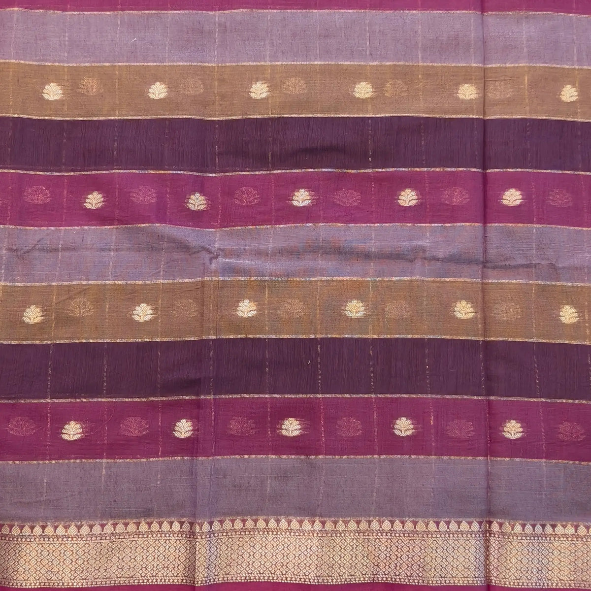 Multicoloured (Purple & maroon)soft silk cotton saree with zari woven checks & buttas all over, zari woven double side borders, tissue pallu,multicoloured running blouse with borders & buttas. NS28