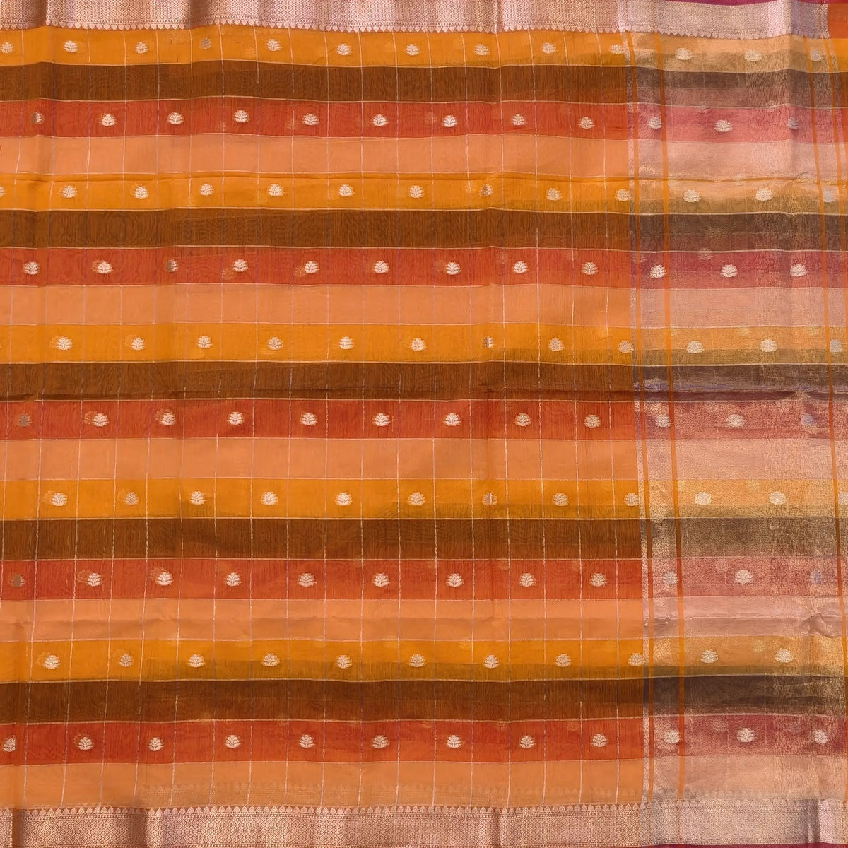 Multicoloured (Orange & yellow)soft silk cotton saree with zari woven checks & buttas all over, zari woven double side borders, tissue pallu,multicoloured running blouse with borders & buttas. NS25