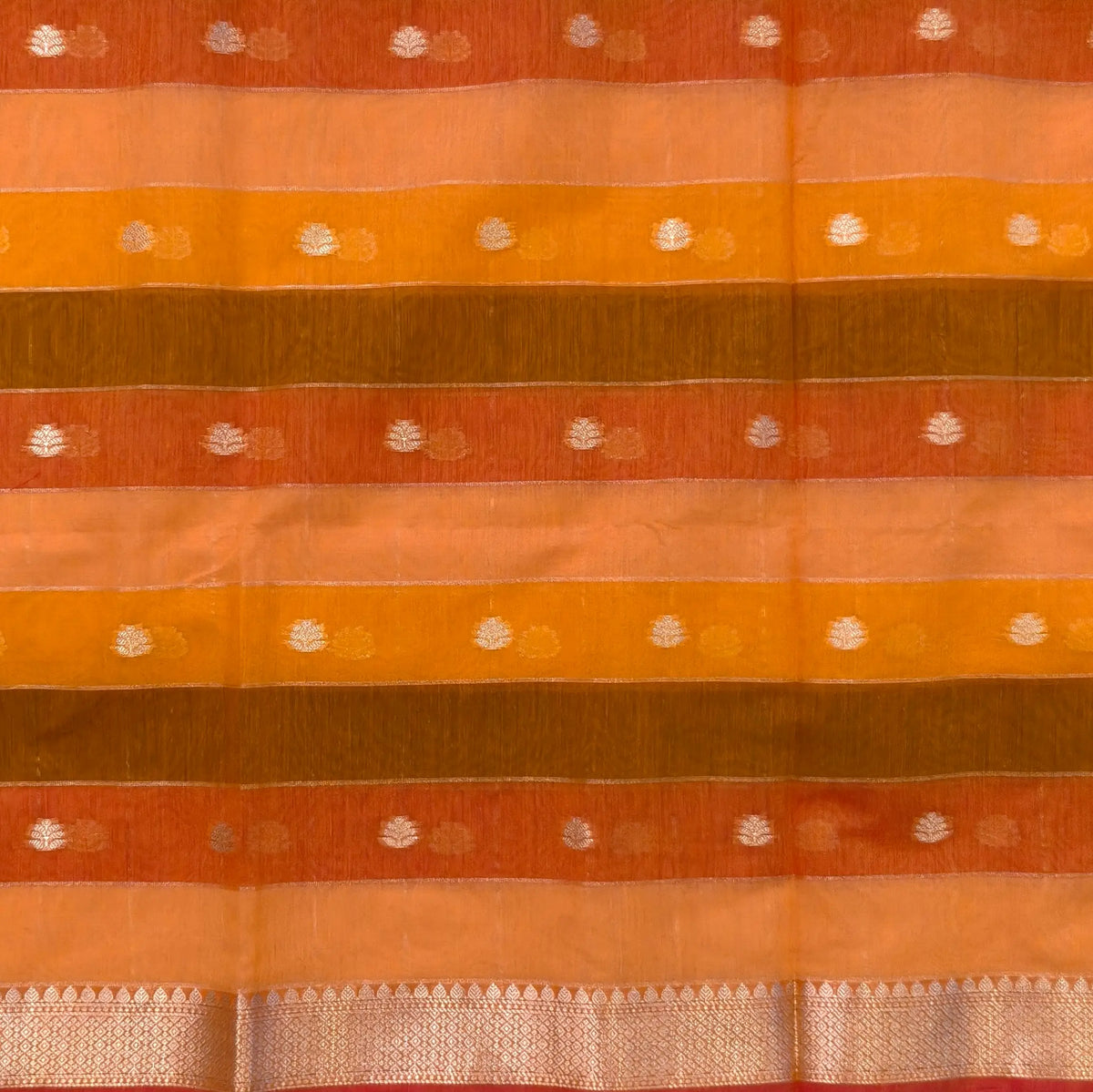 Multicoloured (Orange & yellow)soft silk cotton saree with zari woven checks & buttas all over, zari woven double side borders, tissue pallu,multicoloured running blouse with borders & buttas. NS25