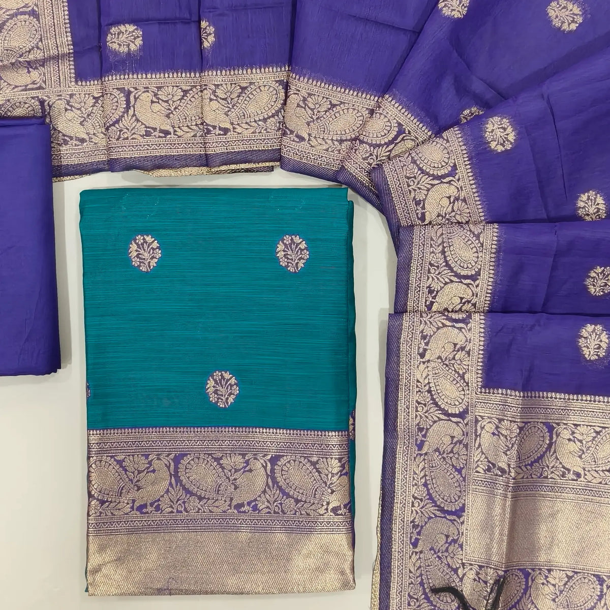 Turquoise green benarasi zari woven premium silk cotton unstitched salwar material,buttas on front, zari weaving on yoke, rich daman(Lightweight, Lining Needed)violet silky bottom, benarasi zari woven silk cotton dupatta with borders. OC261714