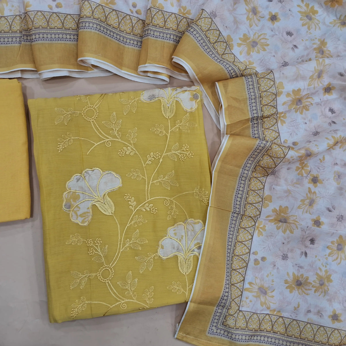 Yellow mul chanderi unstitched salwar material, applique work on panel, embroidery on front (Thin, Soft, Lining Needed) matching santoon bottom, silk cotton digital printed dupatta. OC263106