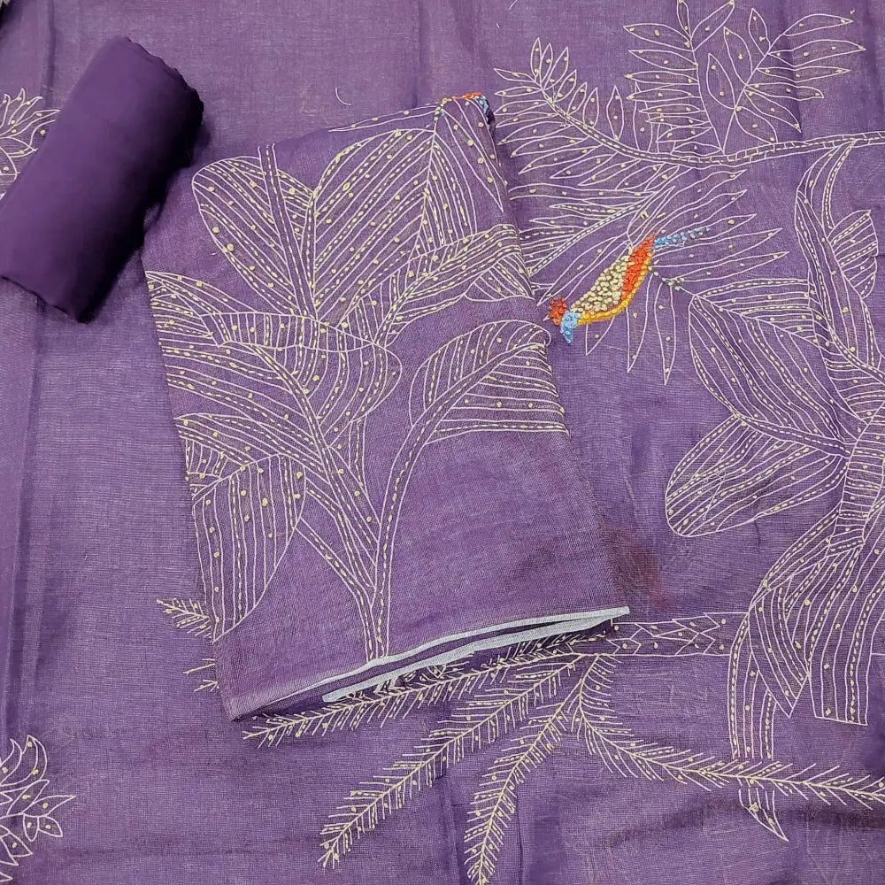 Purple fabric with embroidered white leaf patterns and a small orange bird detail