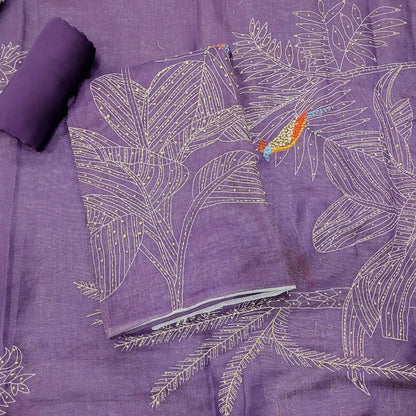 Purple fabric with embroidered white leaf patterns and a small orange bird detail