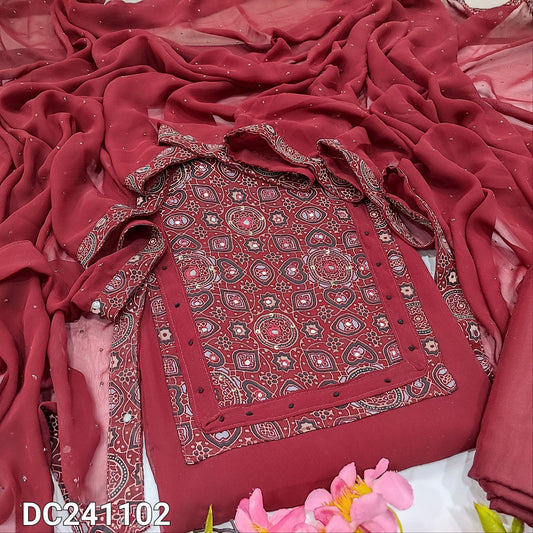 CODE DC241102 : Reddish maroon semi georgette unstitched salwar material, ajrak printed yoke with real mirror work(lining needed)matching silky fabric provided for both bottom &lining, glitter dew drop work on semi georgette dupatta.