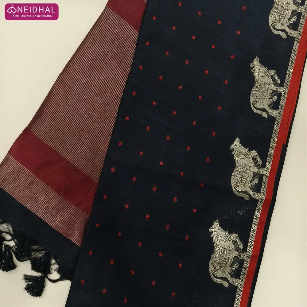 Black with maroon fancy silk cotton saree with thread woven buttas all over the body of the saree, double side borders with pichwai zari short pallu and zari striped blouse with cow motif weaving. CODE NS02