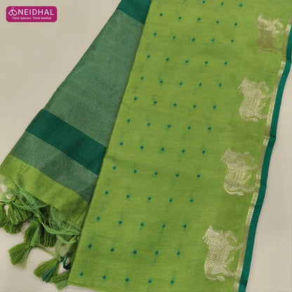 Light green with turquoise green fancy silk cotton saree with thread woven buttas all over the body of the saree, double side borders with pichwai zari short pallu and zari striped blouse with cow motif weaving. CODE NS06