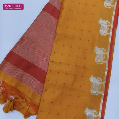 Light orange with reddish maroon fancy silk cotton saree with thread woven buttas all over the body of the saree, double side borders with pichwai zari short pallu and zari striped blouse with cow motif weaving. CODE NS05