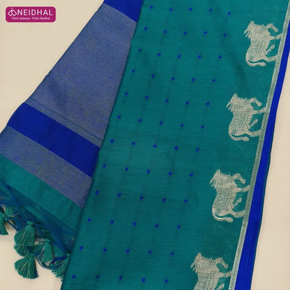 Teal green with royal blue fancy silk cotton saree with thread woven buttas all over the body of the saree, double side borders with pichwai zari short pallu and zari striped blouse with cow motif weaving. CODE NS04