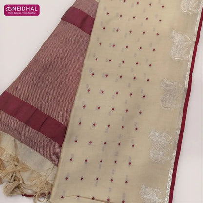 Beige with dark maroon fancy silk cotton saree with thread woven buttas all over the body of the saree, double side borders with pichwai zari short pallu and zari striped blouse with cow motif weaving. CODE NS08