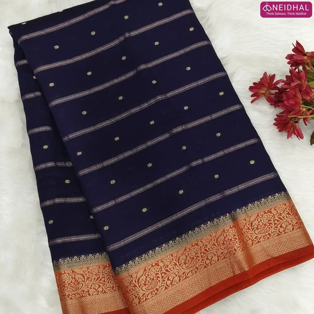 Navy Blue fancy silk saree (soft, silky) with banarasi zari woven double side borders zari woven butttas and stripes allover, contrast zari woven pallu, rust orange zari woven blouse with borders. NS44