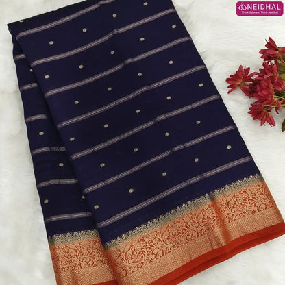 Navy Blue fancy silk saree (soft, silky) with banarasi zari woven double side borders zari woven butttas and stripes allover, contrast zari woven pallu, rust orange zari woven blouse with borders. NS44