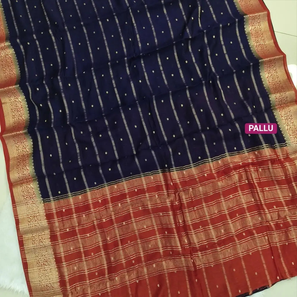 Navy Blue fancy silk saree (soft, silky) with banarasi zari woven double side borders zari woven butttas and stripes allover, contrast zari woven pallu, rust orange zari woven blouse with borders. NS44