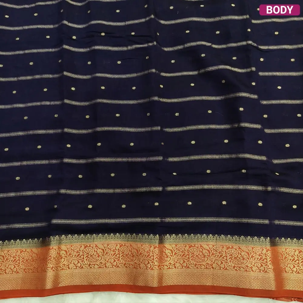 Navy Blue fancy silk saree (soft, silky) with banarasi zari woven double side borders zari woven butttas and stripes allover, contrast zari woven pallu, rust orange zari woven blouse with borders. NS44