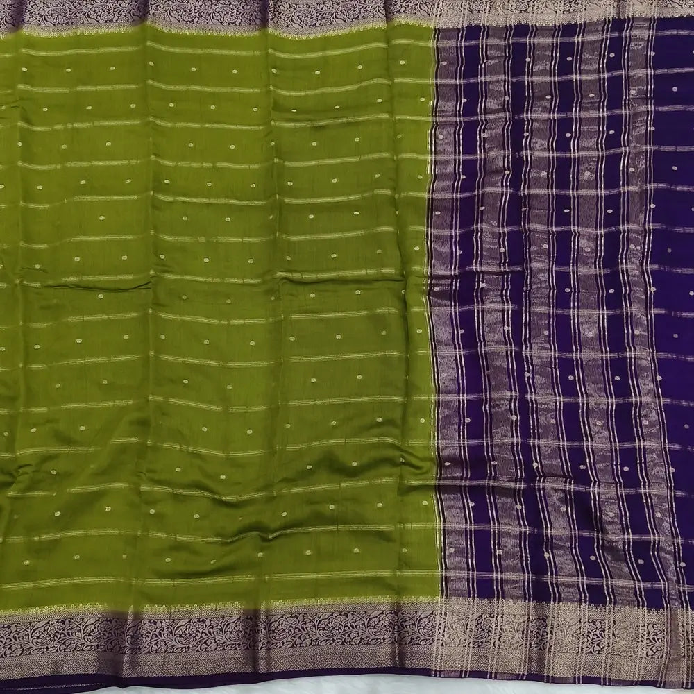 Mossy Green fancy silk saree (soft, silky) with banarasi zari woven double side borders zari woven butttas and stripes allover, contrast zari woven pallu, dark purple zari woven blouse with borders. NS43