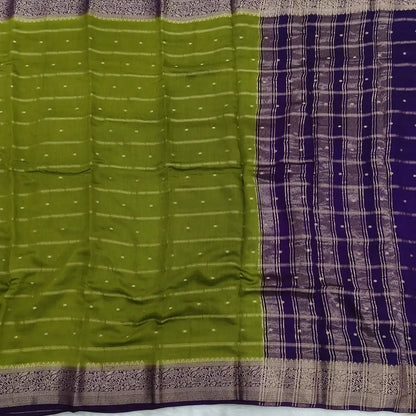 Mossy Green fancy silk saree (soft, silky) with banarasi zari woven double side borders zari woven butttas and stripes allover, contrast zari woven pallu, dark purple zari woven blouse with borders. NS43