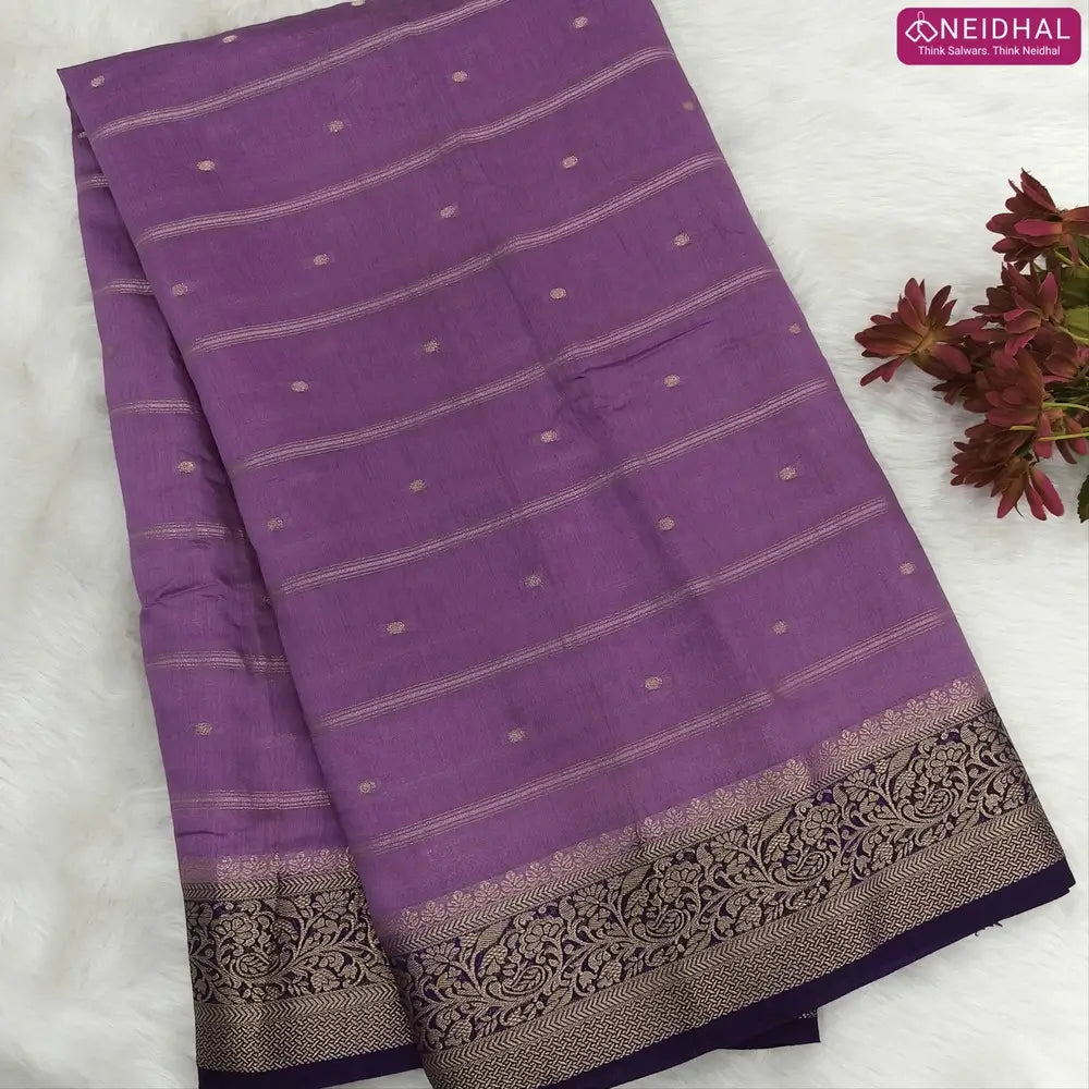 Lilac fancy silk saree (soft, silky) with banarasi zari woven double side borders zari woven butttas and stripes allover, contrast zari woven pallu, dark purple zari woven blouse with borders. NS42