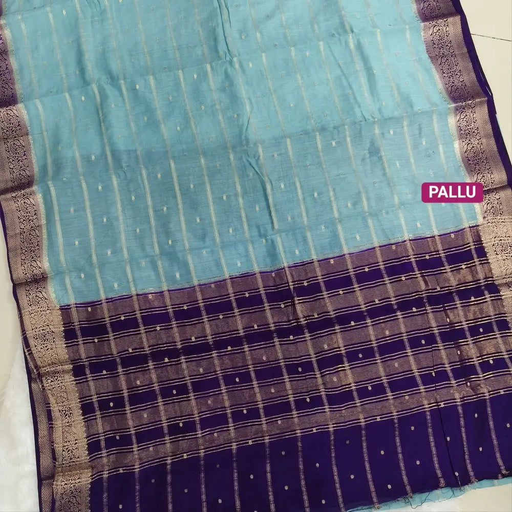 Pastel Blue fancy silk saree (soft, silky) with banarasi zari woven double side borders zari woven butttas and stripes allover, contrast zari woven pallu, dark purple zari woven blouse with borders. NS41