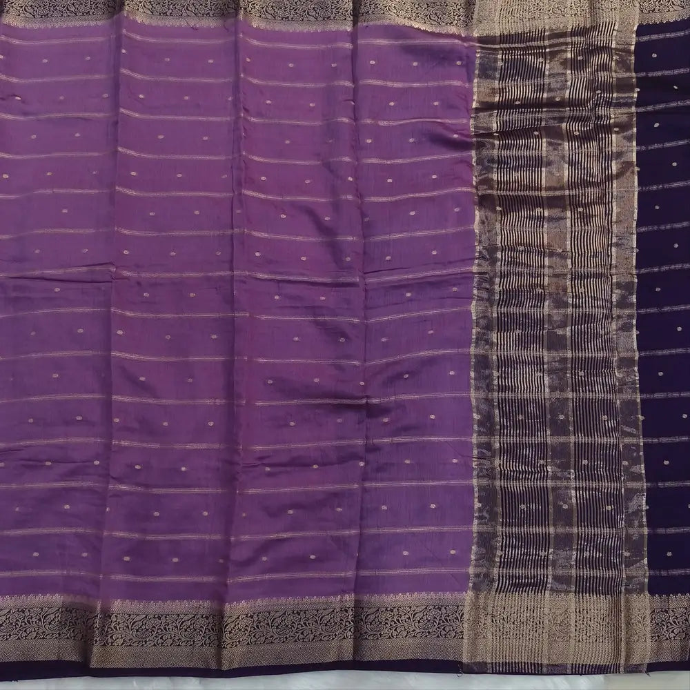 Lilac fancy silk saree (soft, silky) with banarasi zari woven double side borders zari woven butttas and stripes allover, contrast zari woven pallu, dark purple zari woven blouse with borders. NS42