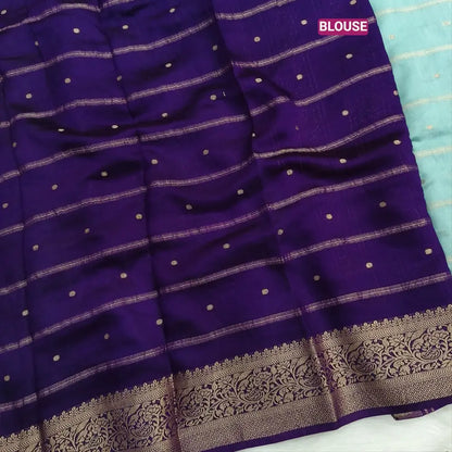 Pastel Blue fancy silk saree (soft, silky) with banarasi zari woven double side borders zari woven butttas and stripes allover, contrast zari woven pallu, dark purple zari woven blouse with borders. NS41