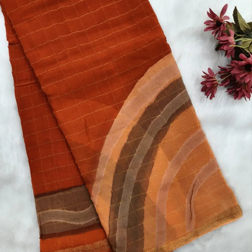 Rust Orange Viscous Chanderi silk saree with shibori prints all over and zari checks all over, thin zari woven borders and running viscous chanderi zari woven blouse. NS58