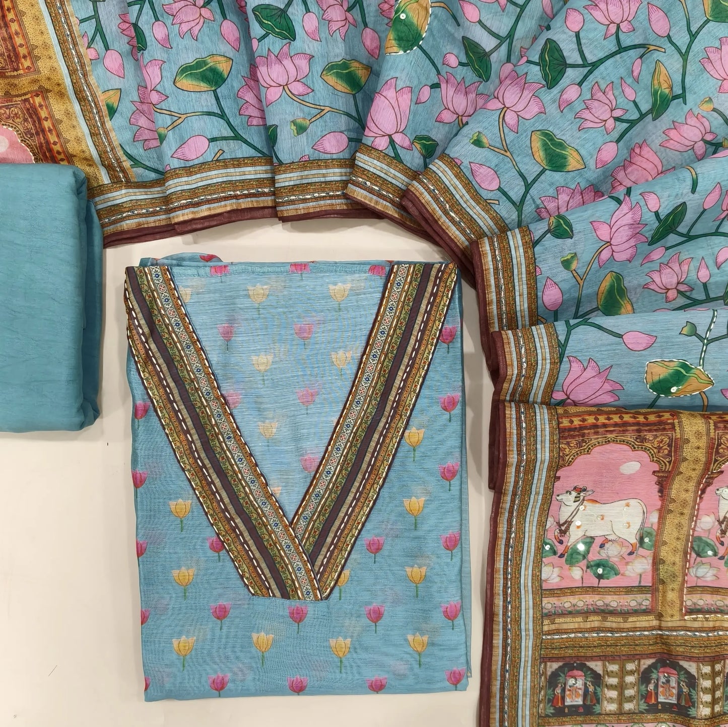 Pastel blue digital printed silk cotton unstitched salwar material, v neck with Katha stitch(lining needed)matching spun cotton bottom, printed silk cotton dupatta with kantha stitch &sequins. CODE JL242616