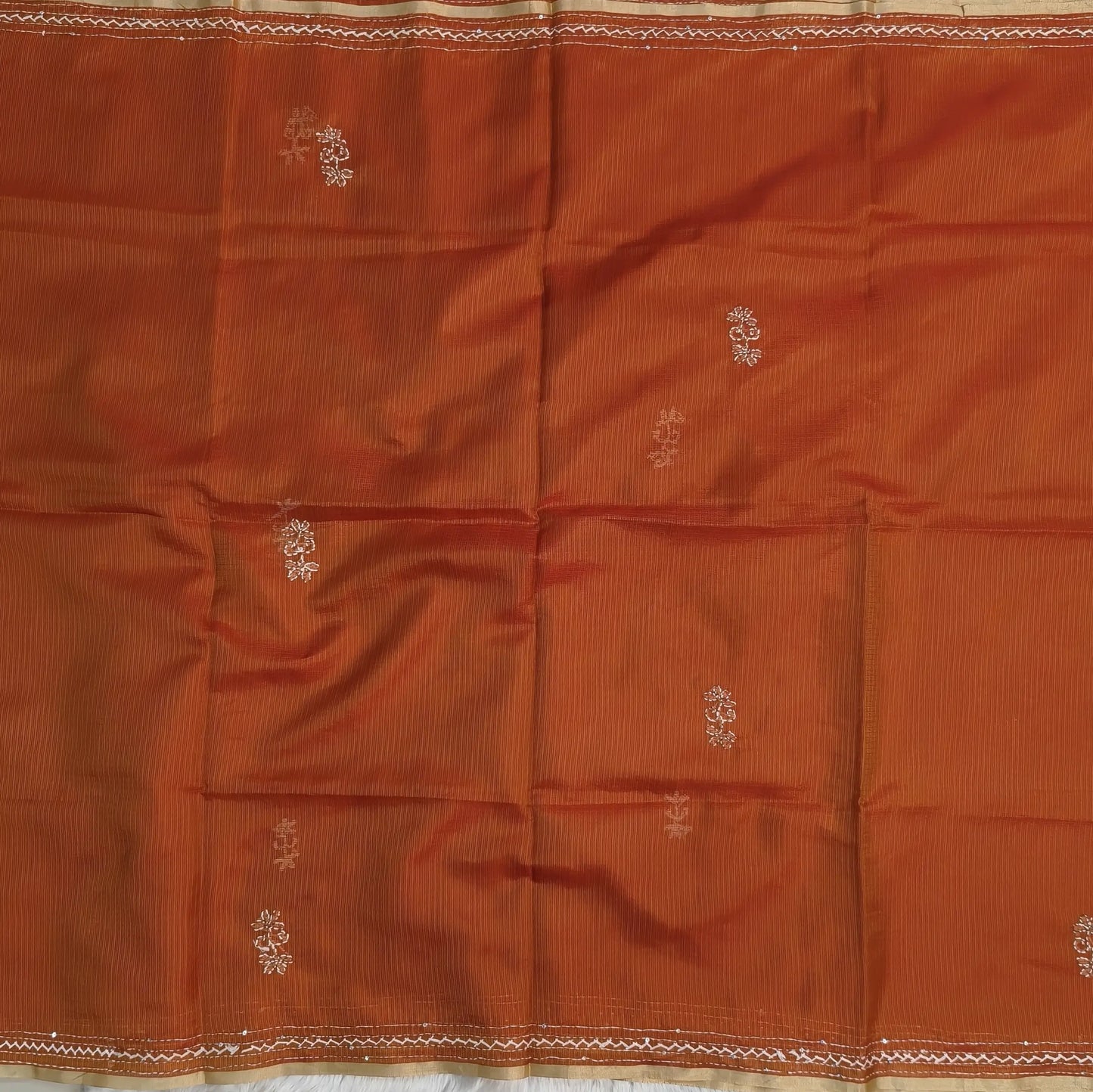 Rust orange premium kota silk saree(soft, thin)with rich hand embroidery work all over,thin tissue borders,rich embroidered pallu,running blouse with embroidery and borders. NS293