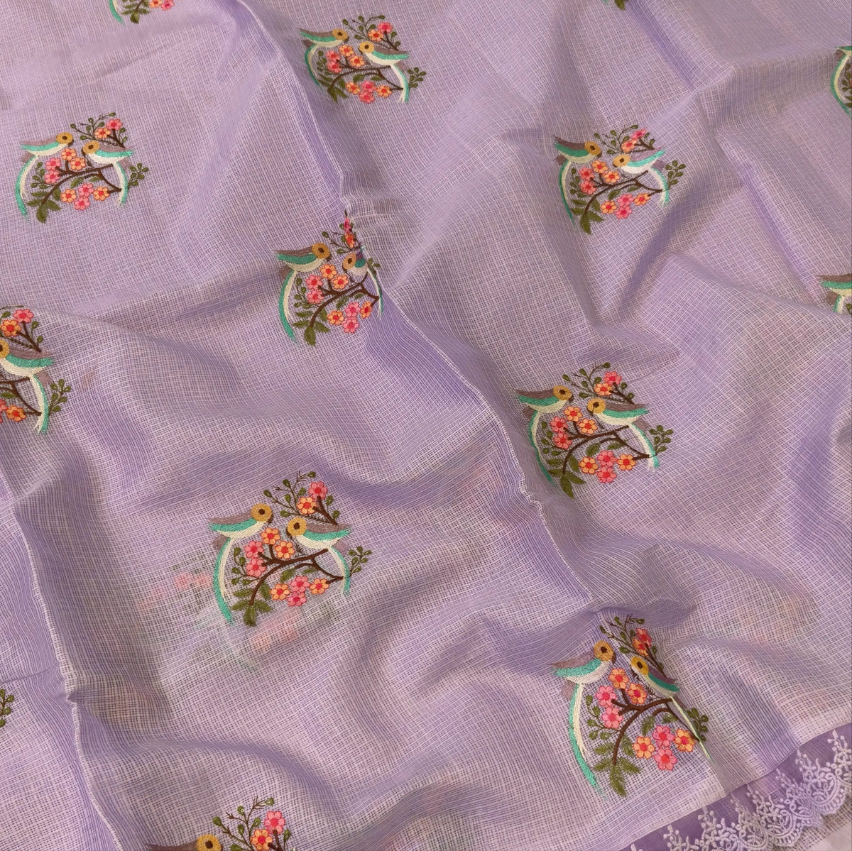 Pastel purple premium kota saree with embroidered bird and floral motifs all over (Thin, Lightweight) lace tapings as borders, rich embroidered pallu, plain running blouse. NS309