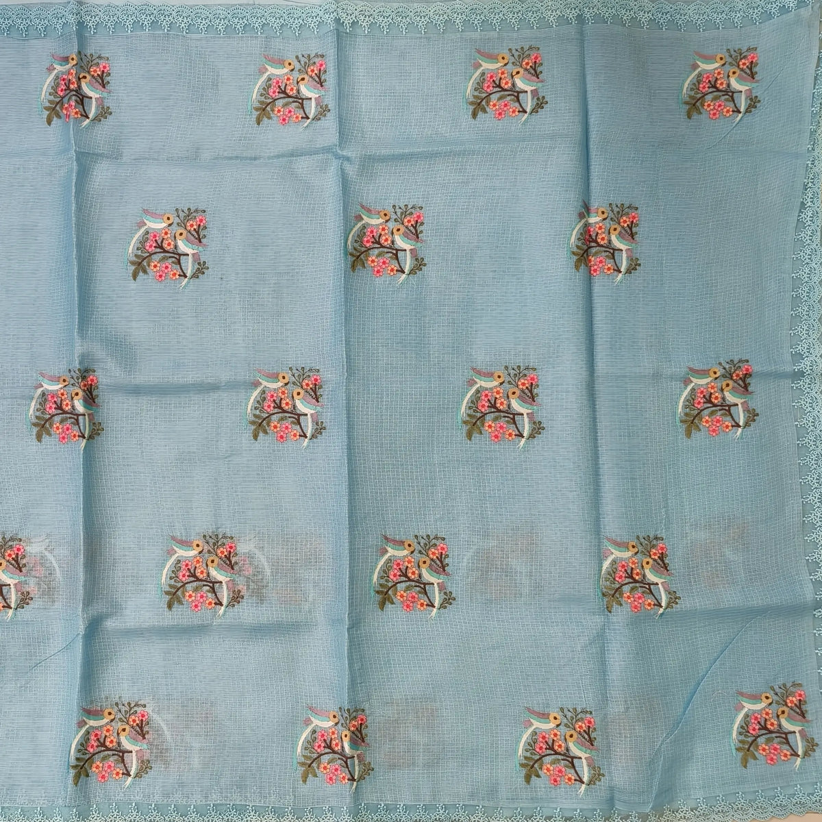Pastel blue premium kota saree with embroidered bird and floral motifs all over (Thin, Lightweight) lace tapings as borders, rich embroidered pallu, plain running blouse. NS310