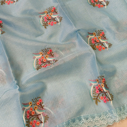 Pastel blue premium kota saree with embroidered bird and floral motifs all over (Thin, Lightweight) lace tapings as borders, rich embroidered pallu, plain running blouse. NS310
