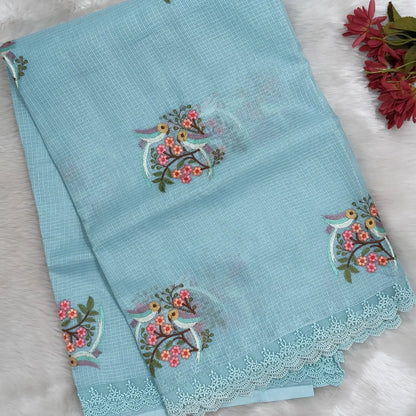 Pastel blue premium kota saree with embroidered bird and floral motifs all over (Thin, Lightweight) lace tapings as borders, rich embroidered pallu, plain running blouse. NS310
