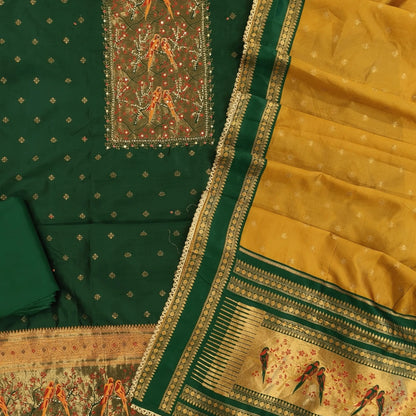 Bottle green silk cotton unstitched salwar material,rich weaving with pearl bead and sequins work on yoke,buttas on front,rich daman,(Lining Needed)spun cotton bottom, buttas on silk cotton dupatta with contrast borders & rich pallu. SP262401