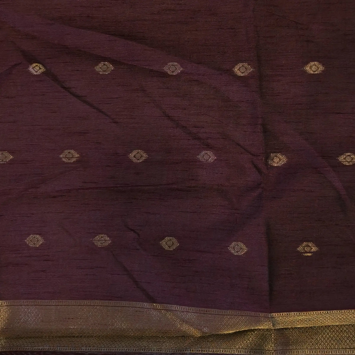 Dark brown semi tussar saree, with rich traditional zari weaving all over (thin, Textured) rich pallu, running blouse with zari woven buttas and borders. NS315
