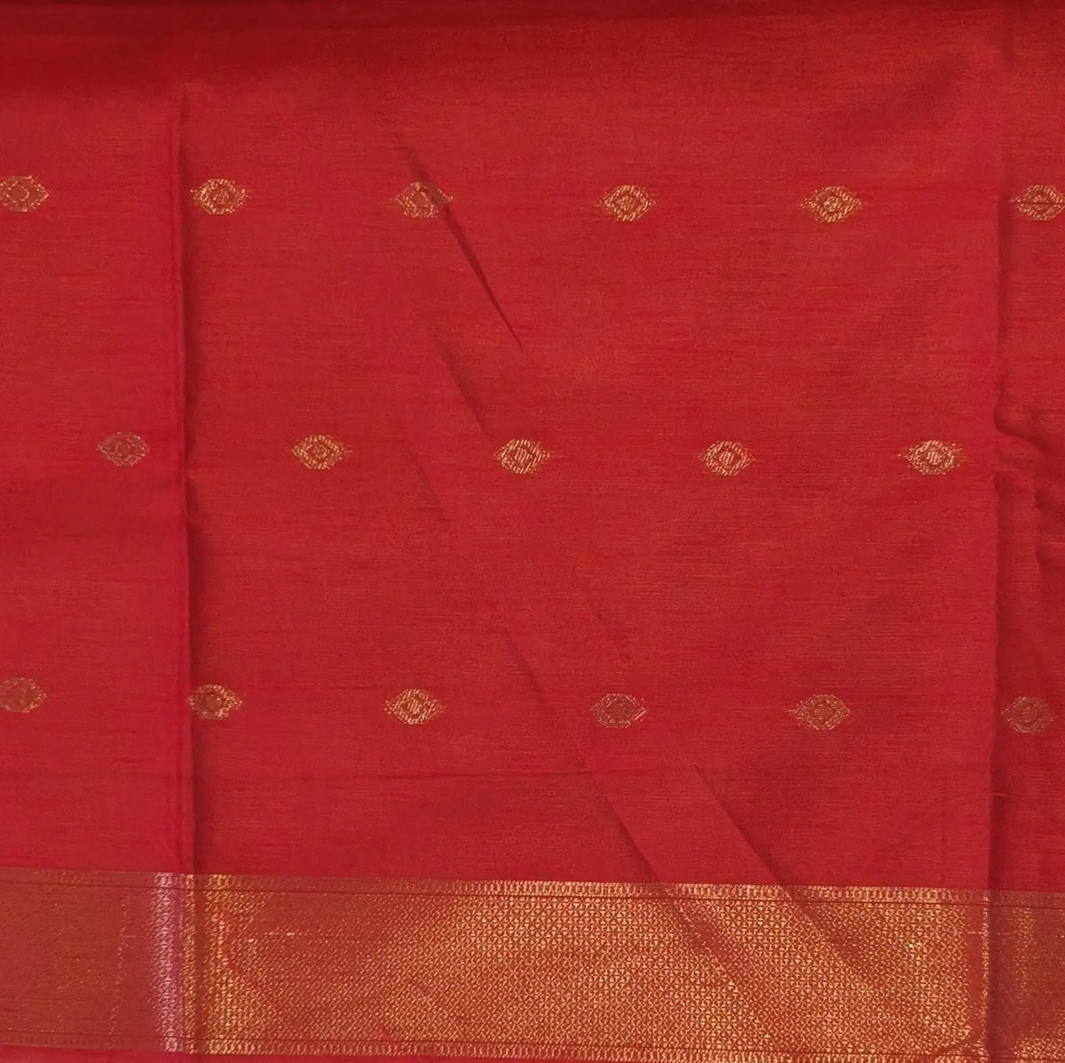 Red semi tussar saree, with rich traditional zari weaving all over (thin, Textured) rich pallu, running blouse with zari woven buttas and borders. NS311