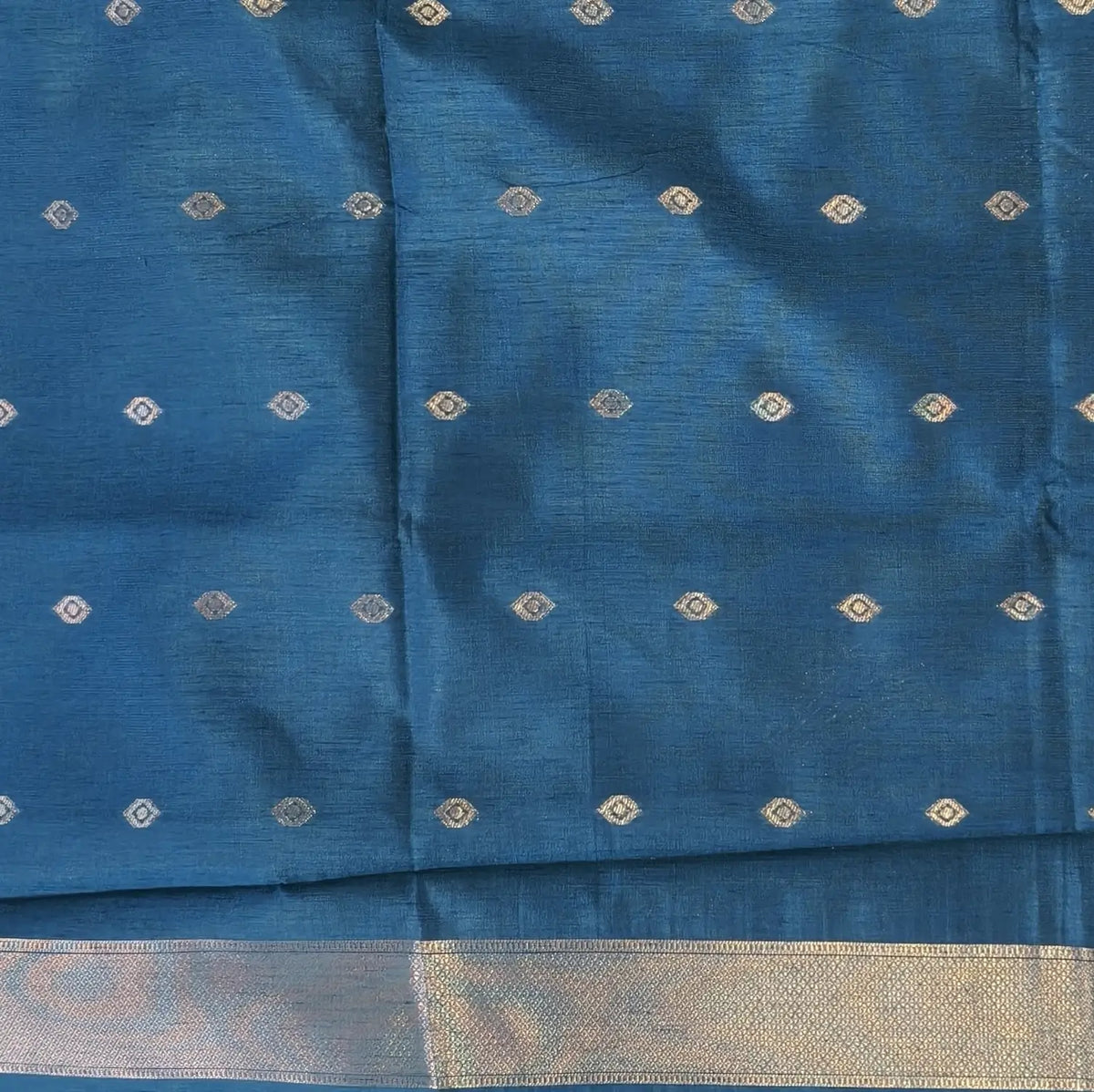 Dark turquoise blue semi tussar saree, with rich traditional zari weaving all over (thin, Textured) rich pallu, running blouse with zari woven buttas and borders. NS318