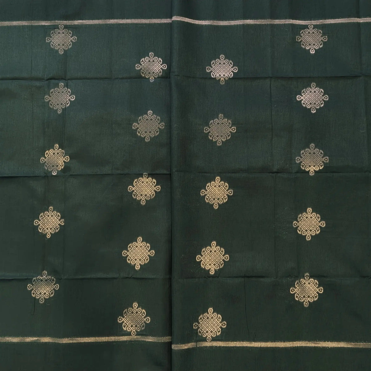 Dark green semi tussar saree, with rich traditional zari weaving all over (thin, Textured) rich pallu, running blouse with zari woven buttas and borders. NS314