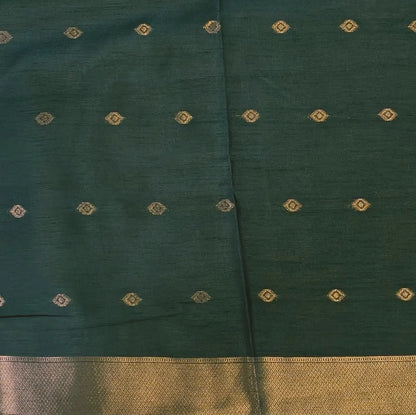 Dark green semi tussar saree, with rich traditional zari weaving all over (thin, Textured) rich pallu, running blouse with zari woven buttas and borders. NS314