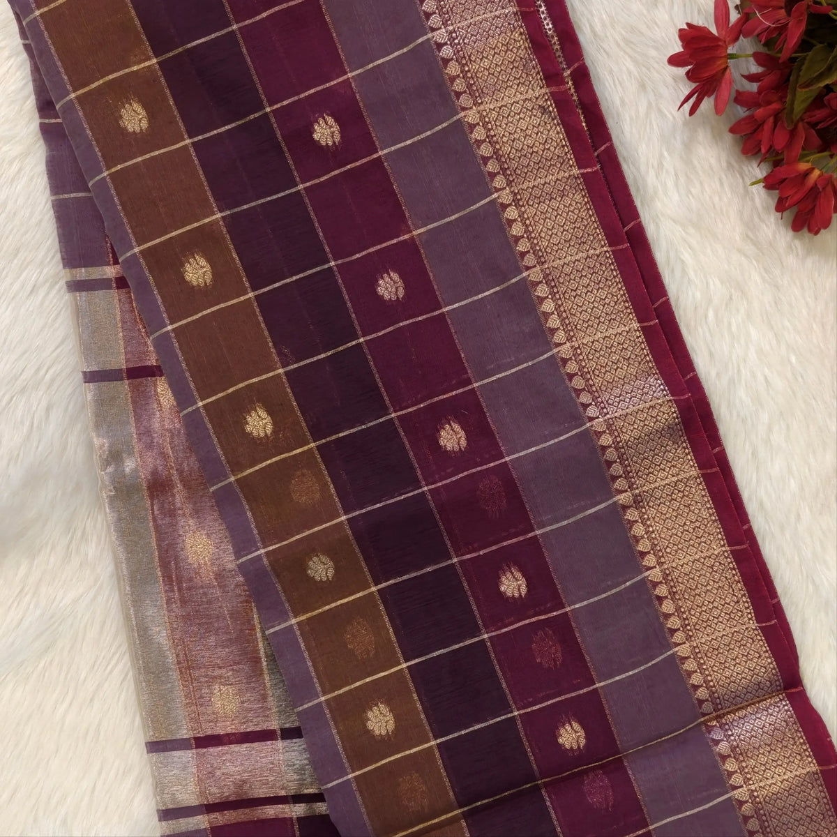 Multicoloured (Purple & maroon)soft silk cotton saree with zari woven checks & buttas all over, zari woven double side borders, tissue pallu,multicoloured running blouse with borders & buttas. NS28