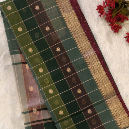 Multicoloured (Dark green & brown)soft silk cotton saree with zari woven checks & buttas all over, zari woven double side borders, tissue pallu,multicoloured running blouse with borders & buttas. NS27
