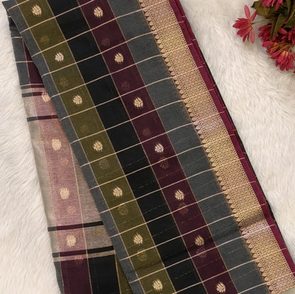Multicoloured (Black, purple & grey)soft silk cotton saree with zari woven checks & buttas all over, zari woven double side borders, tissue pallu,multicoloured running blouse with borders & buttas. NS31
