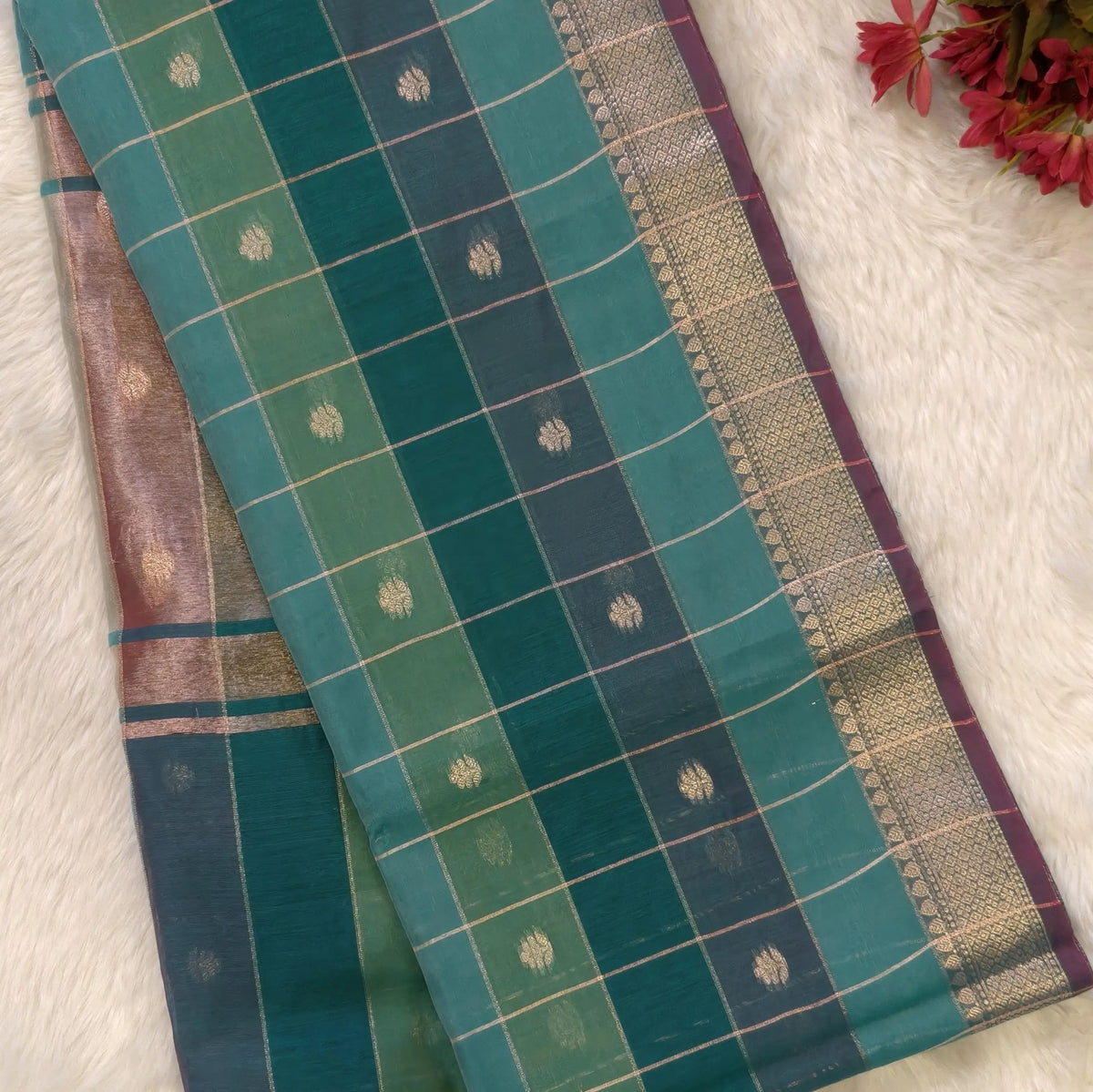 Multicoloured (Turquoise blue & green)soft silk cotton saree with zari woven checks & buttas all over, zari woven double side borders, tissue pallu,multicoloured running blouse with borders & buttas. NS24