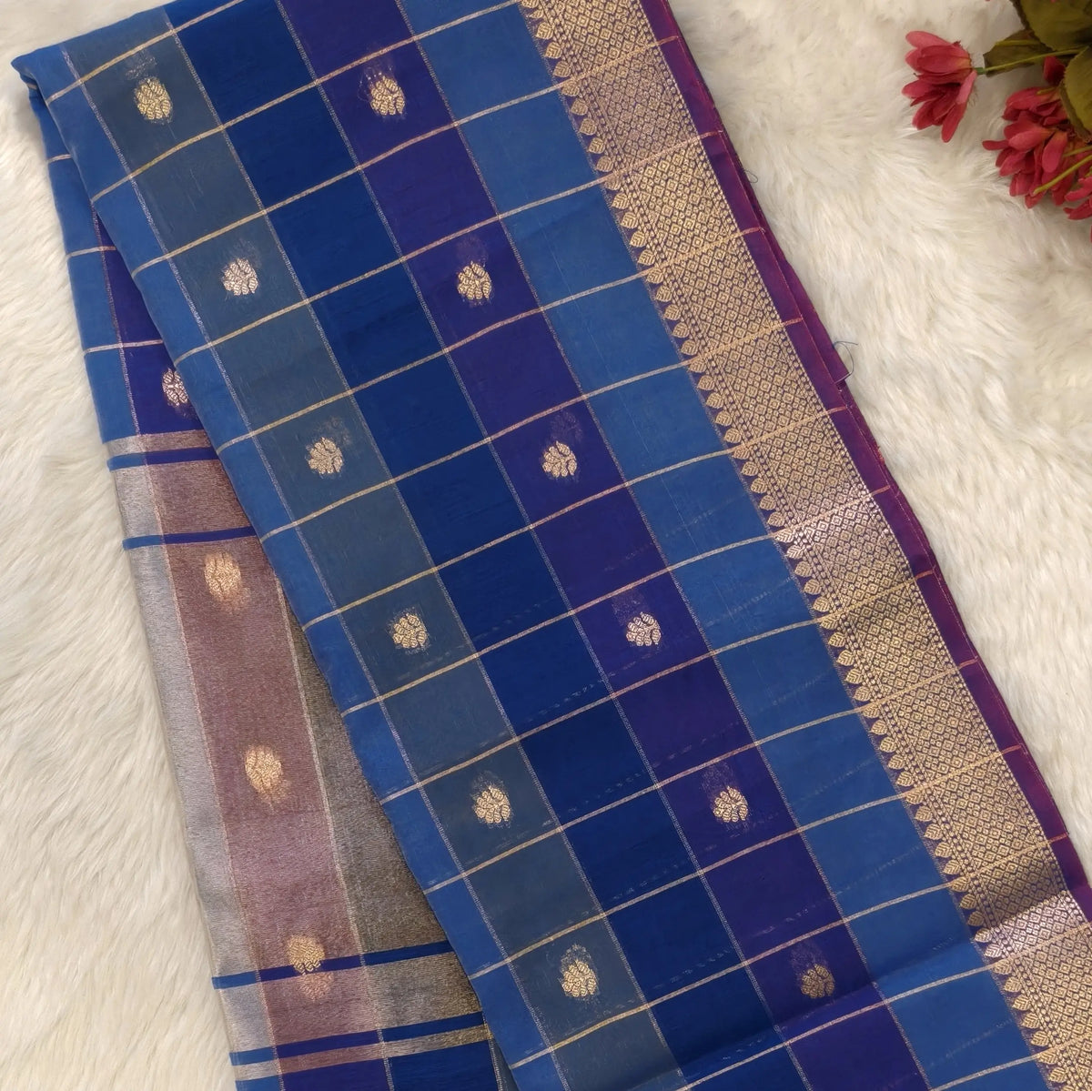 Multicoloured (Light& dark blue)soft silk cotton saree with zari woven checks & buttas all over, zari woven double side borders, tissue pallu,multicoloured running blouse with borders & buttas. NS32
