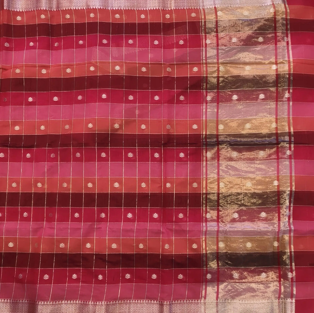 Multicoloured (Pink & red)soft silk cotton saree with zari woven checks & buttas all over, zari woven double side borders, tissue pallu,multicoloured running blouse with borders & buttas. NS26