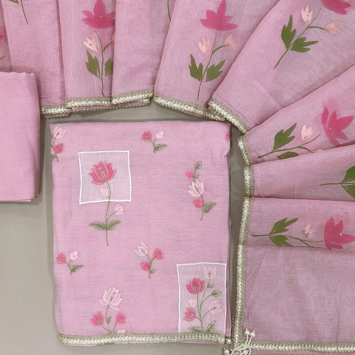 Designer pastel pink mul chanderi unstitched salwar material,rich floral thread embroidery work on front, ( soft,lining needed)santoon bottom, hand brush paint work on mul chanderi dupatta with lace tapping and beaded tassles. OC260902