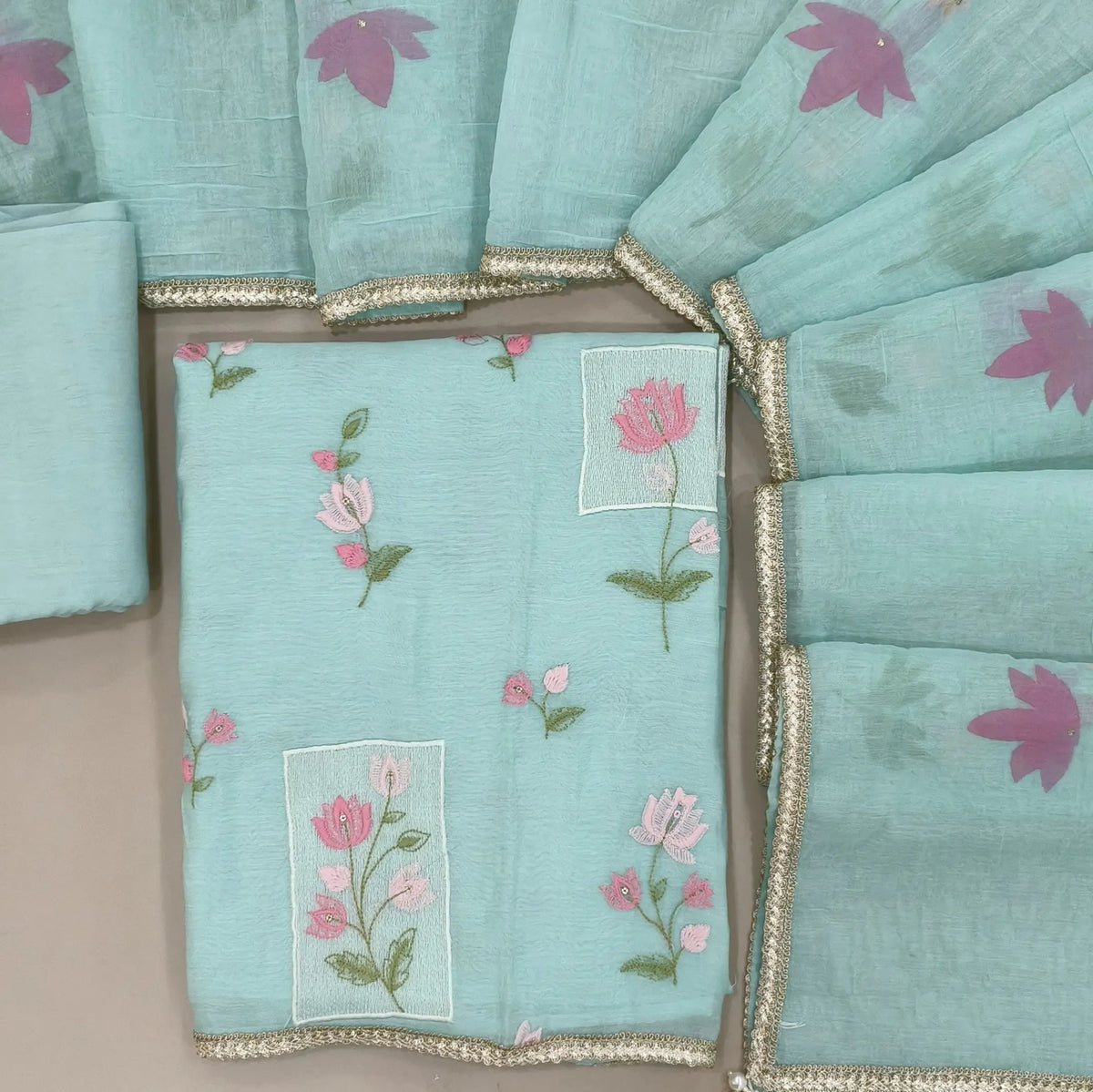 Designer sea green mul chanderi unstitched salwar material,rich floral thread embroidery work on front, ( soft,lining needed)santoon bottom, hand brush paint work on mul chanderi dupatta with lace tapping and beaded tassles. OC260901